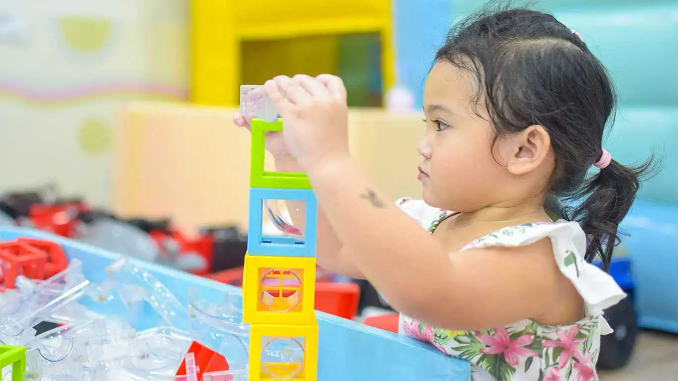 little girl playing with cubes